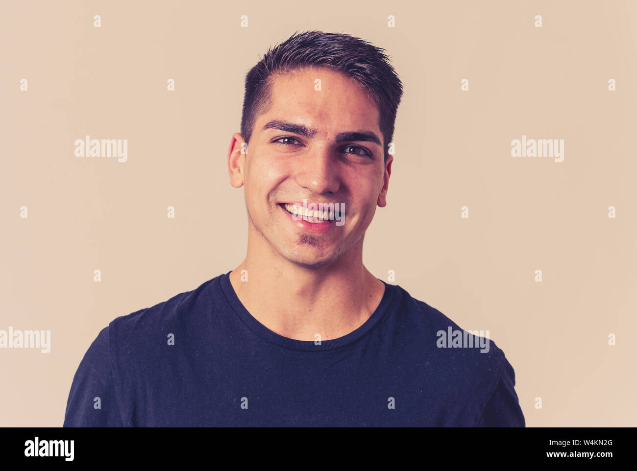 Portrait of attractive young model with happy face and beautiful smile. Handsome masculine millennial man in his 20s. Isolated on white. In People, fa Stock Photo