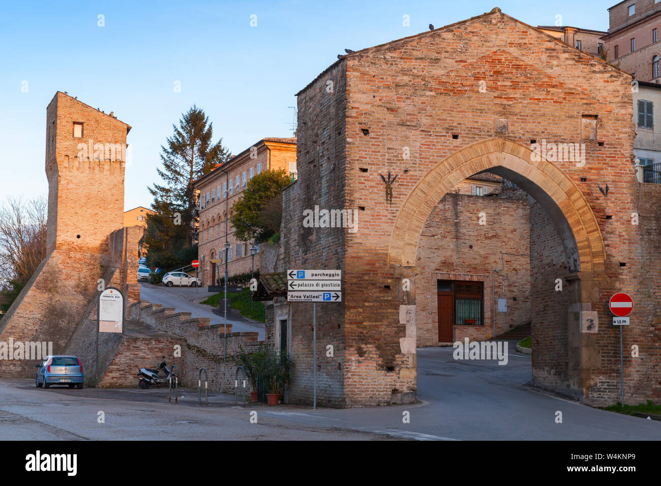 Fermo, Italy - February 8, 2016: Street view of Fermo with stone gate and old town fortifications Stock Photo