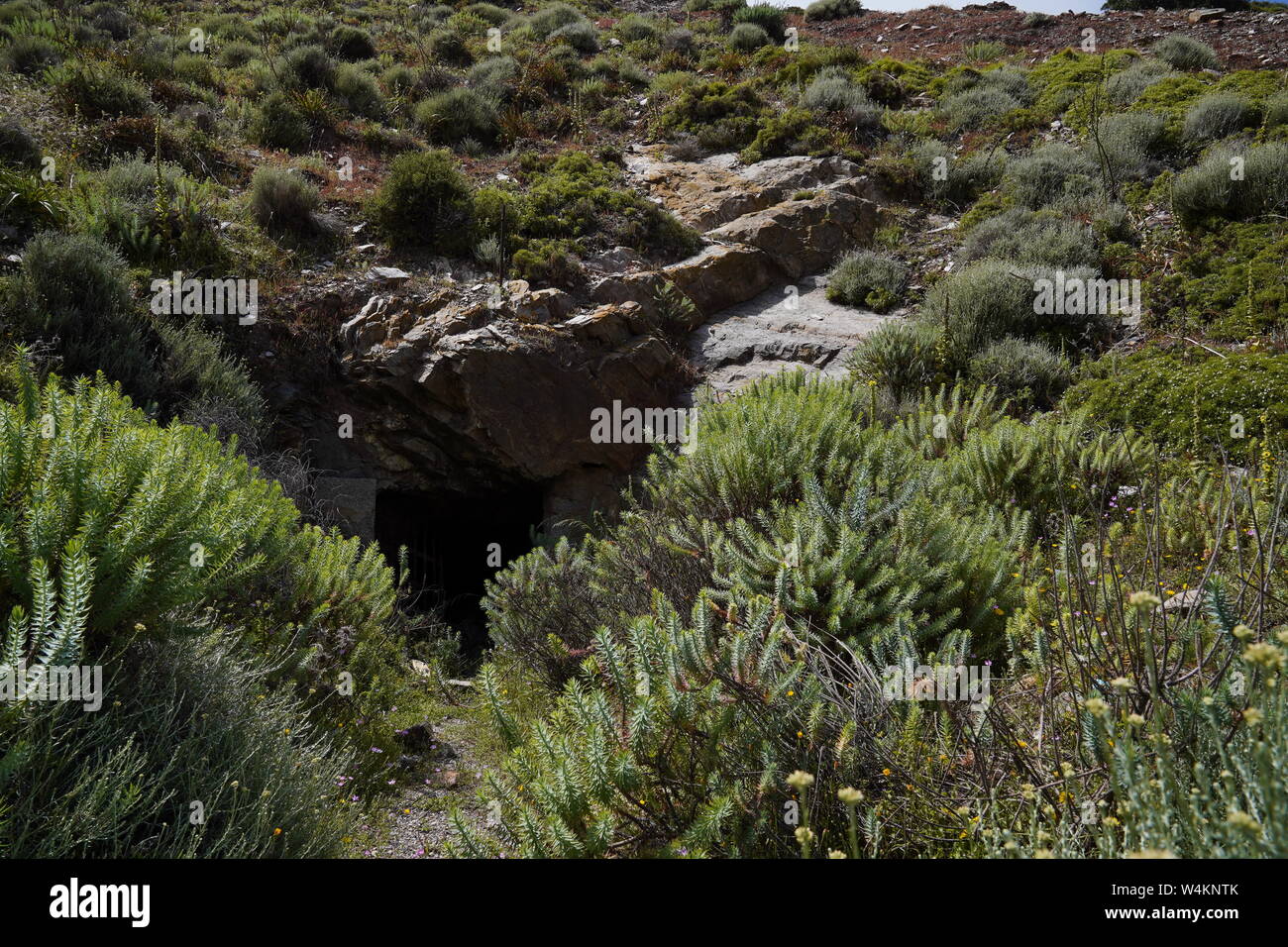Lost places, Rusty grid barrier in front of a cave in Argientiera Stock Photo