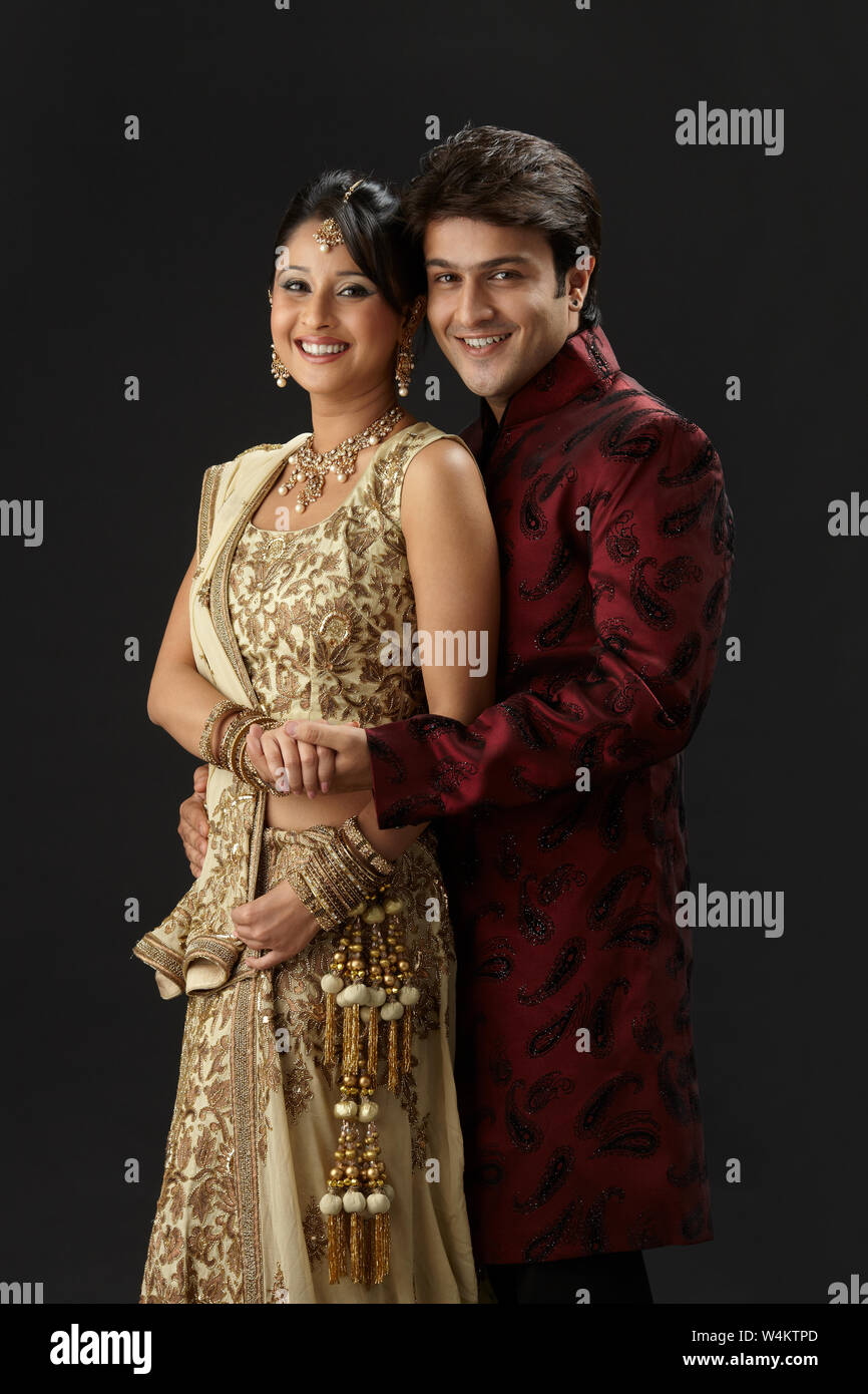 Indian newlywed couple standing together and smiling Stock Photo - Alamy
