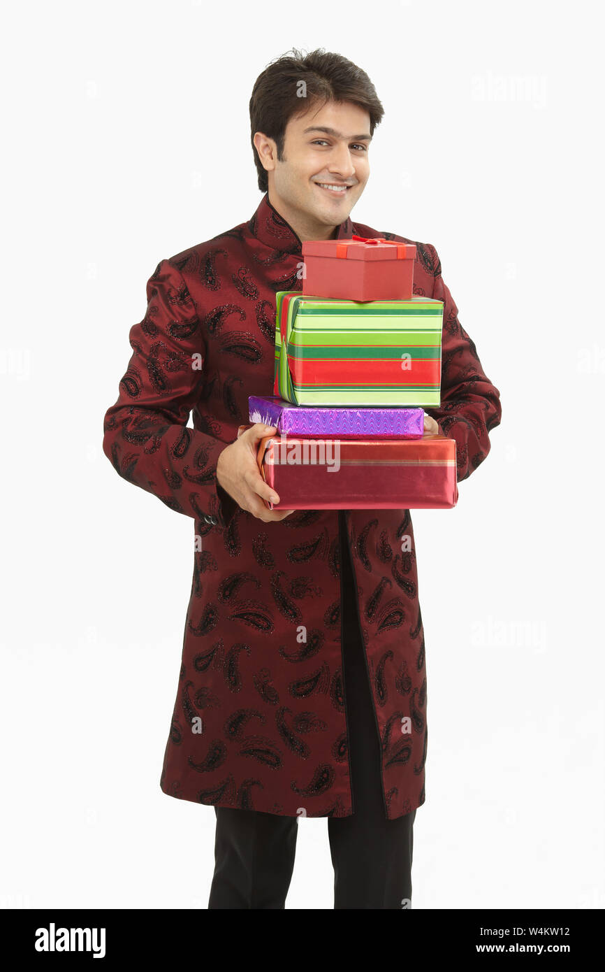Indian bride holding gift boxes and smiling Stock Photo