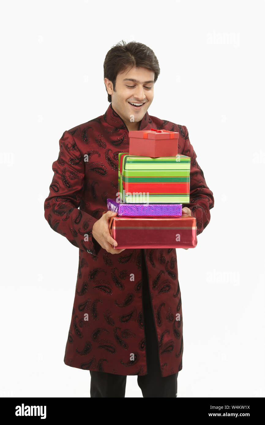 Indian bride holding gift boxes and smiling Stock Photo