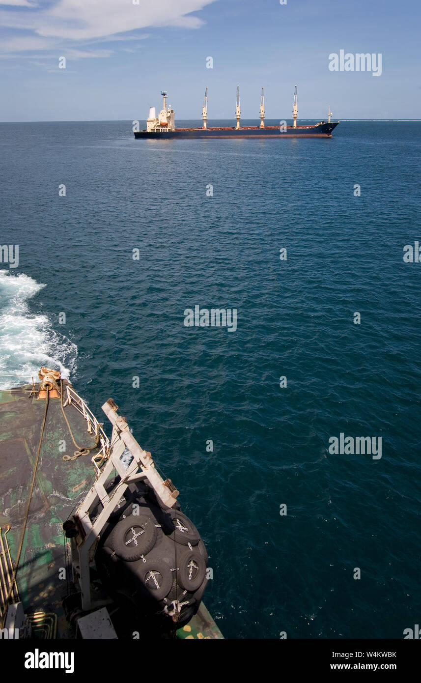 Mining, managing & transporting of titanium mineral sands. Bulk carrier with cargo of titanium mineral sands leaving deep water transhipment point. Stock Photo