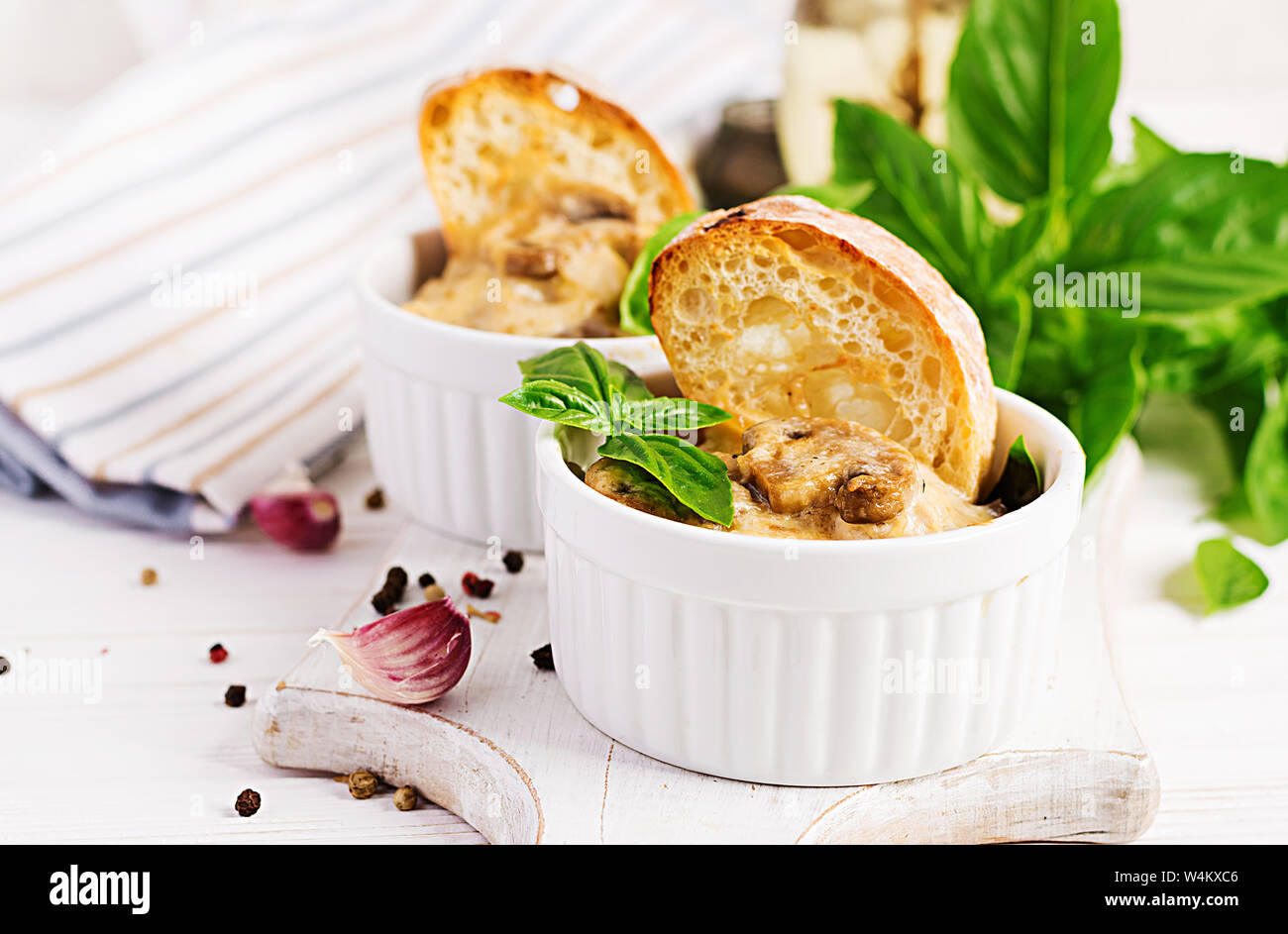 Baked mushroom julienne with chicken, cheese and toast in pots Stock