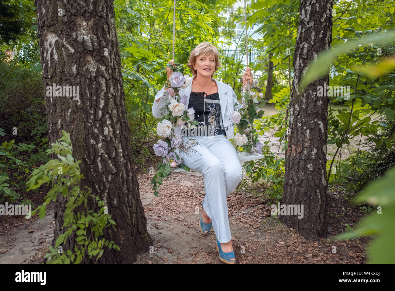 Elderly woman swinging in the park hi-res stock photography and images ...