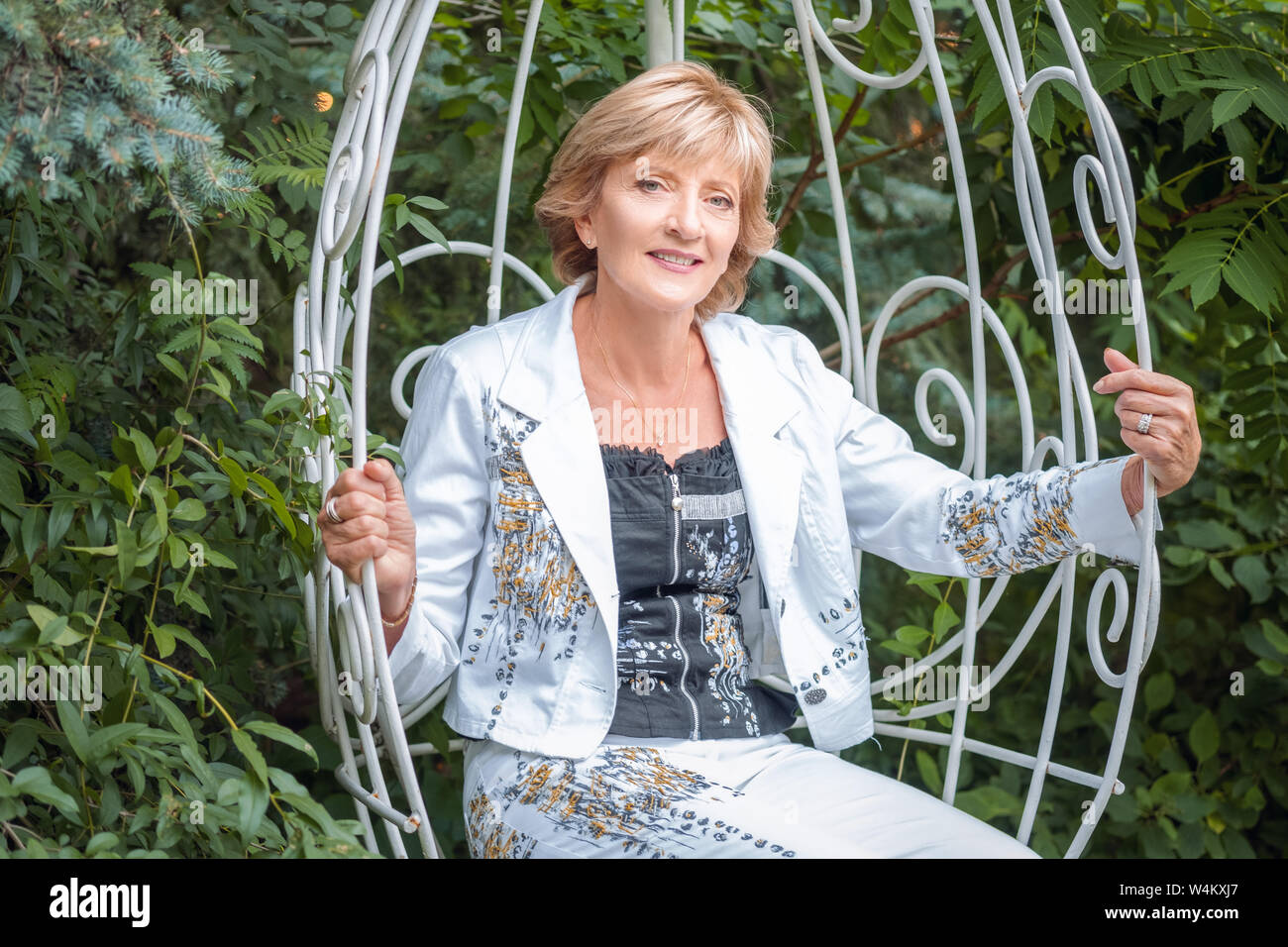 Mature woman swinging in park hi-res stock photography and images - Alamy