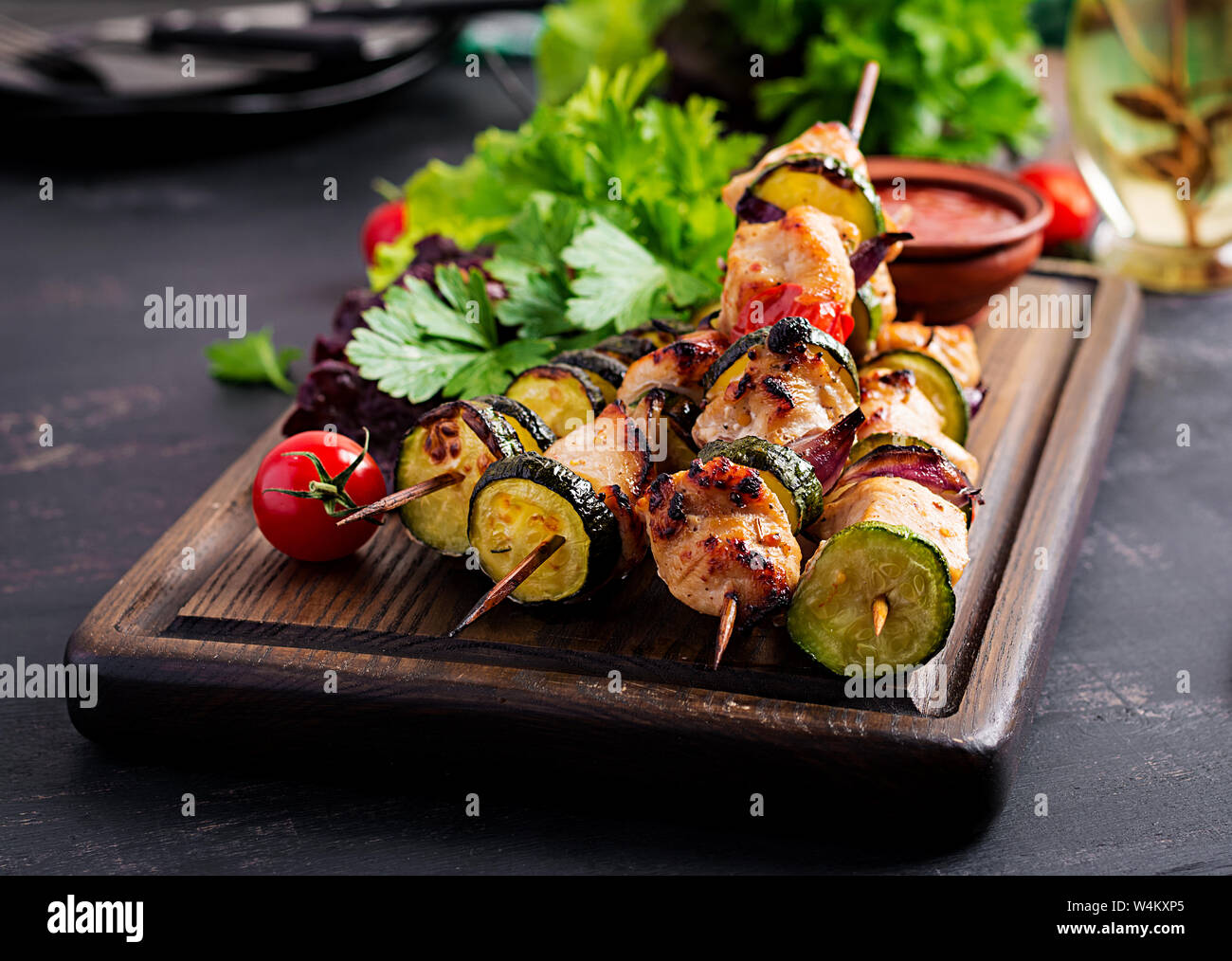 Grilled meat skewers, chicken  shish kebab with zucchini, tomatoes and red onions. Barbecue food. Stock Photo