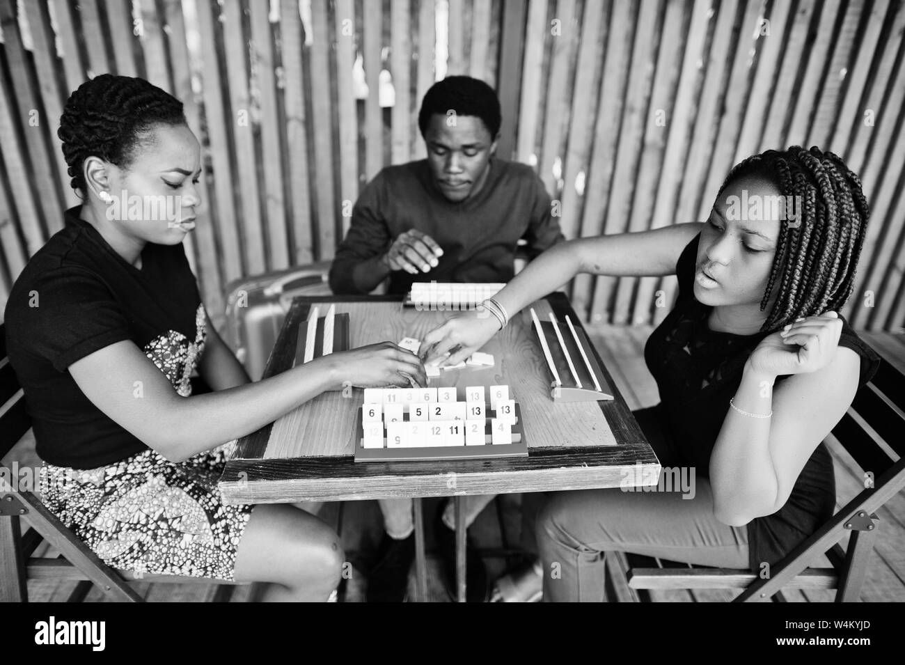 Group of three african american friends play table games Stock Photo