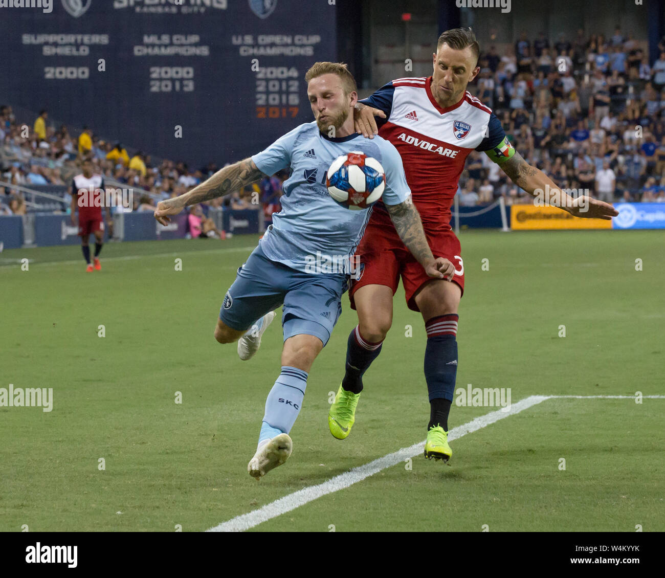 Kansas City, Kansas, USA. 20th July, 2019. Sporting KC forward Johnny Russell #7 (l) is on offense against FC Dallas defender Reto Ziegler #3 (r) during the 2nd half of the game. Credit: Serena S.Y. Hsu/ZUMA Wire/Alamy Live News Stock Photo