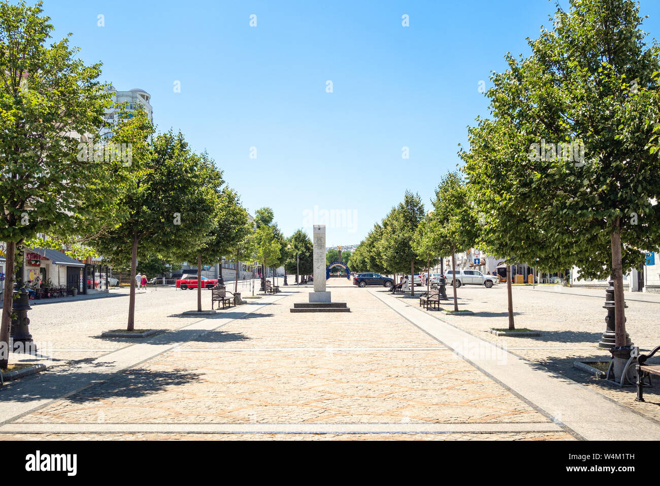 NOVOROSSIYSK, RUSSIA - JULY 7, 2019: view of pedestrian part of street of the Novorossiysk Republic with obelisk. Novorossiysk is city in Krasnodar Kr Stock Photo
