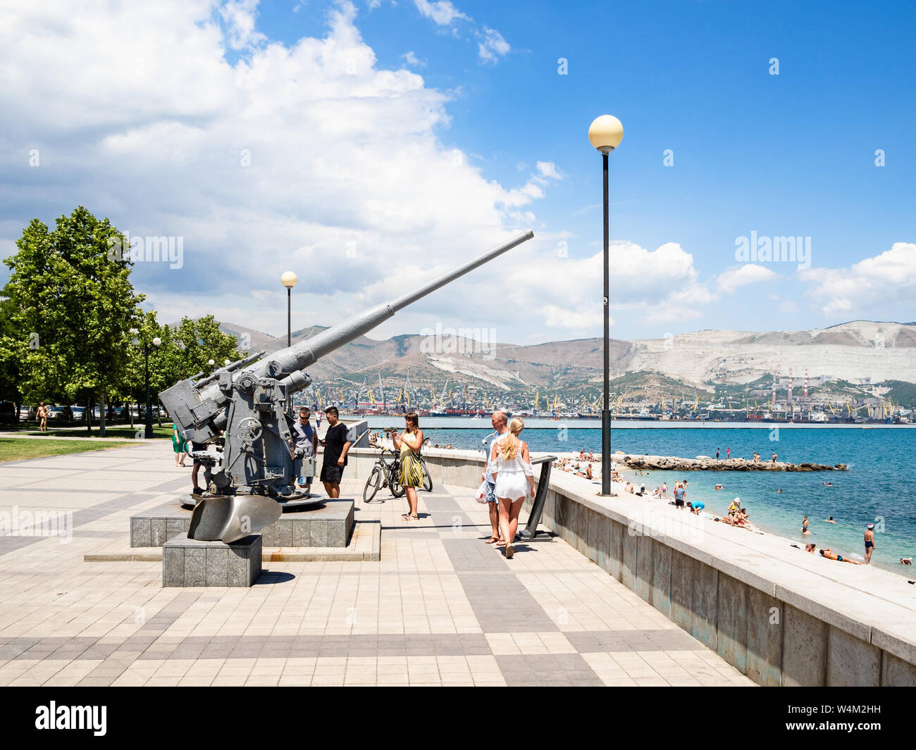 NOVOROSSIYSK, RUSSIA - JULY 7, 2019: tourists near memorial antiaircraft gun on Admiral Serebryakov Embankment. Novorossiysk is city in Krasnodar Krai Stock Photo