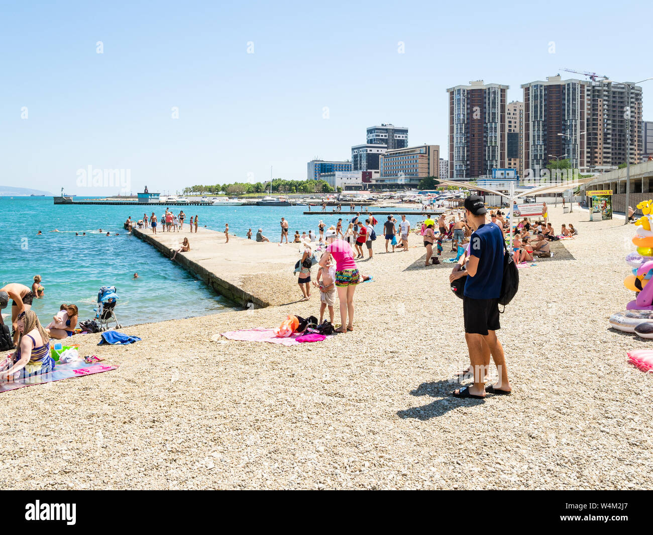 NOVOROSSIYSK, RUSSIA - JULY 7, 2019: people on urban beach along Admiral Serebryakov Embankment in Novorossiysk city. Novorossiysk is city in Krasnoda Stock Photo