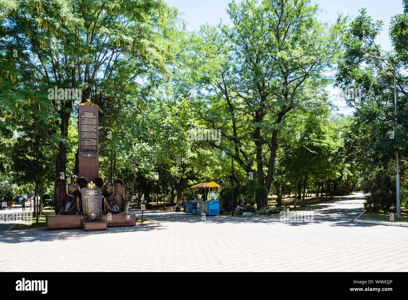 NOVOROSSIYSK, RUSSIA - JULY 7, 2019: people in green Park named after M Frunze and Monument to Novorossiysk residents fallen in undeclared wars in Nov Stock Photo