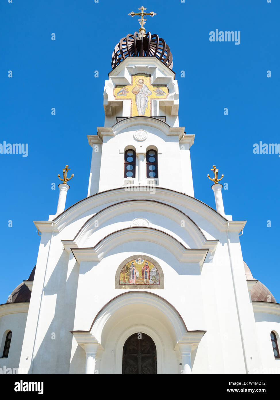 NOVOROSSIYSK, RUSSIA - JULY 7, 2019: facade of Church of St Peter and St Fevronia near Chapel of St Nicholas the Wonderworker on Admiral Serebryakov E Stock Photo