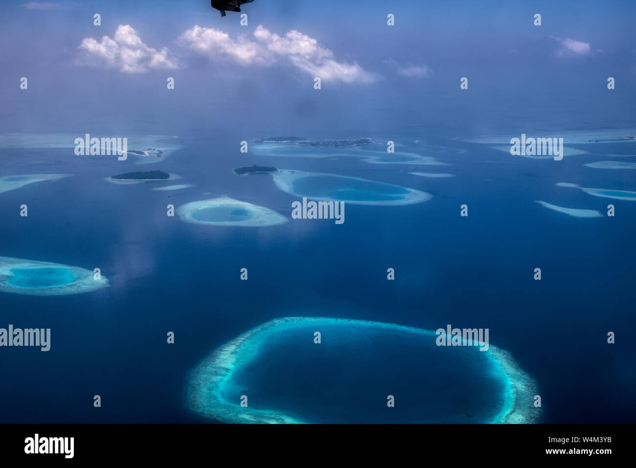 This unique image shows the Maldives photographed from a plane from above. You can see the atolls in the sea well. Stock Photo