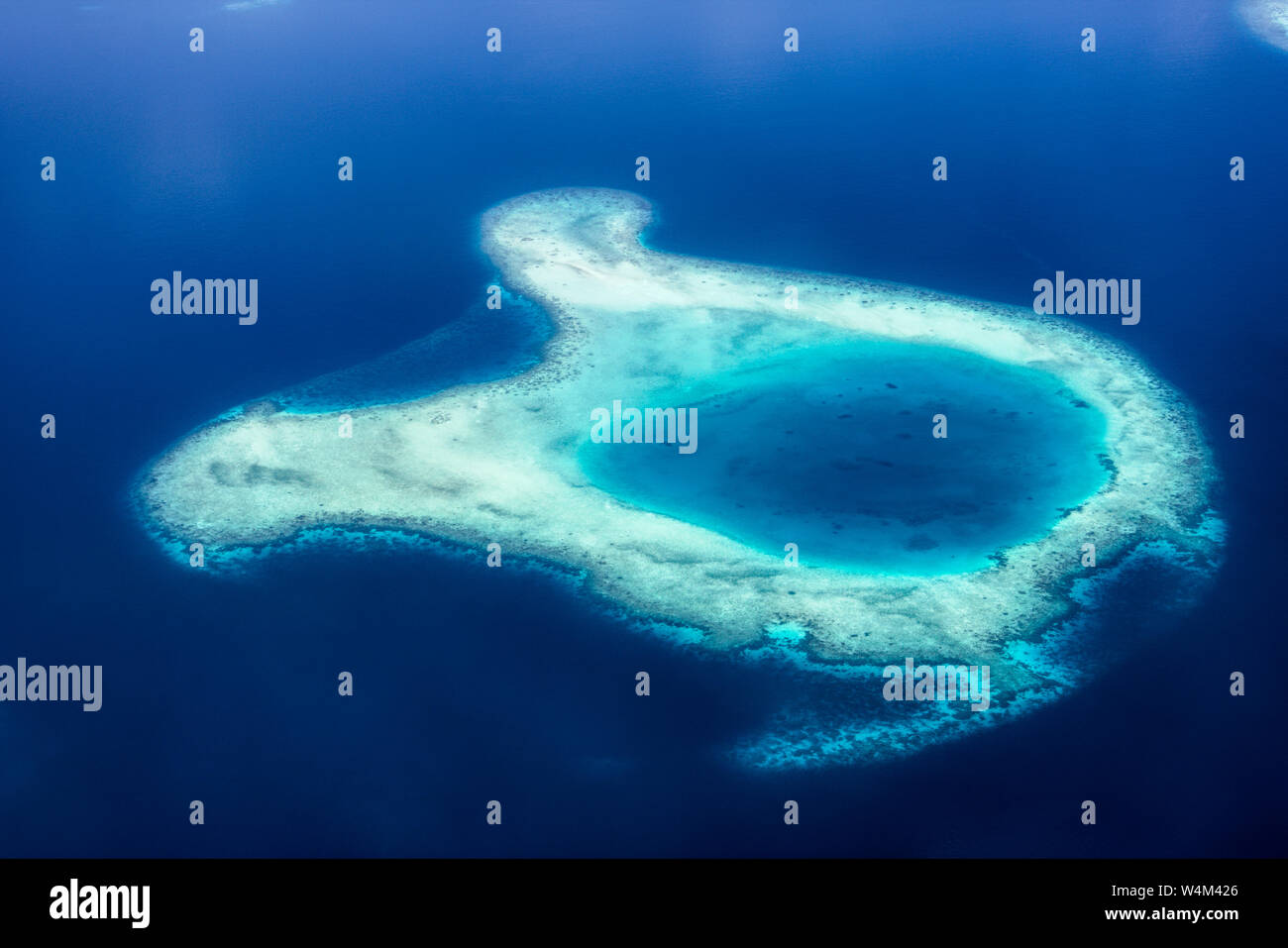 This unique image shows the Maldives photographed from a plane from above. You can see the atolls in the sea well. Stock Photo