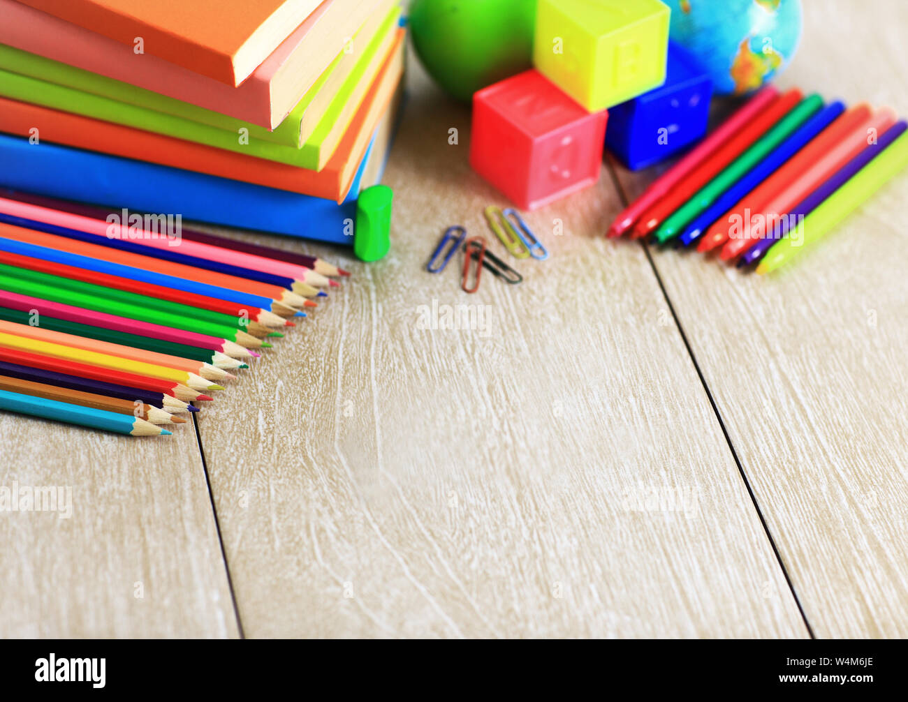 School Supplies Lying On The Wooden Floor Along With Books Dice