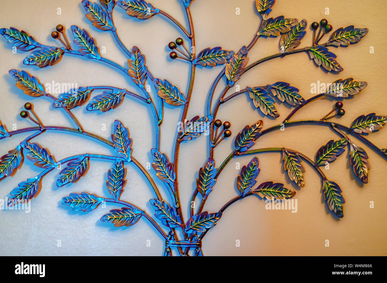 Interior wall decoration/forged metal wall decoration in a home. Design of leaves on vines. Stock Photo