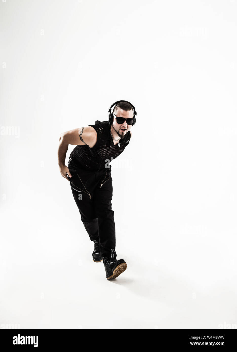rapper with headphones takes breakdancing. photo on a white background ...