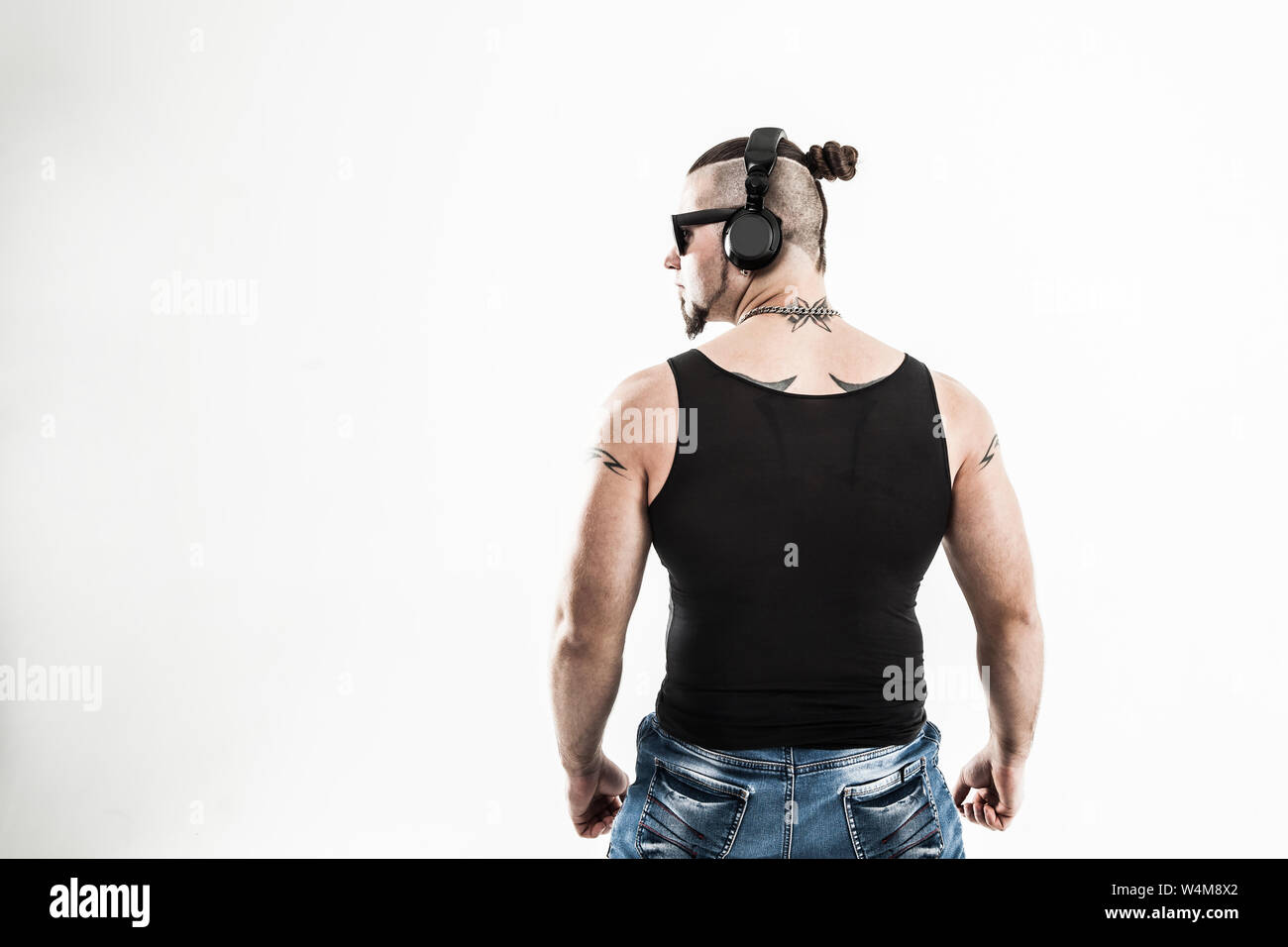 Young Rapper Back View rear view - DJ - rapper with a stylish hairstyle with headphones on a ...