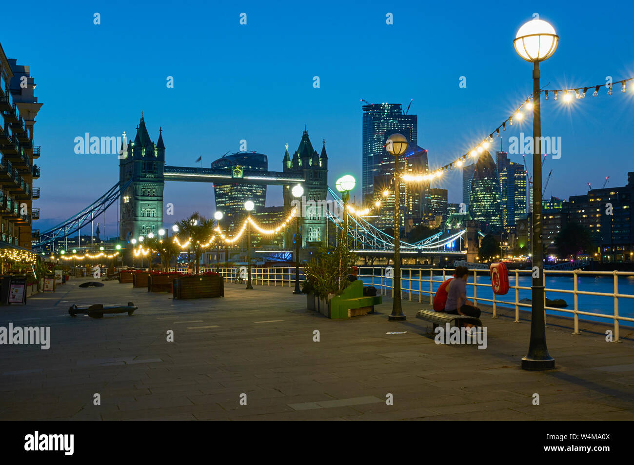 Tower Bridge, London UK, illuminated at dusk, from Butlers Wharf, Bermondsey, on the South Bank of the Thames Stock Photo