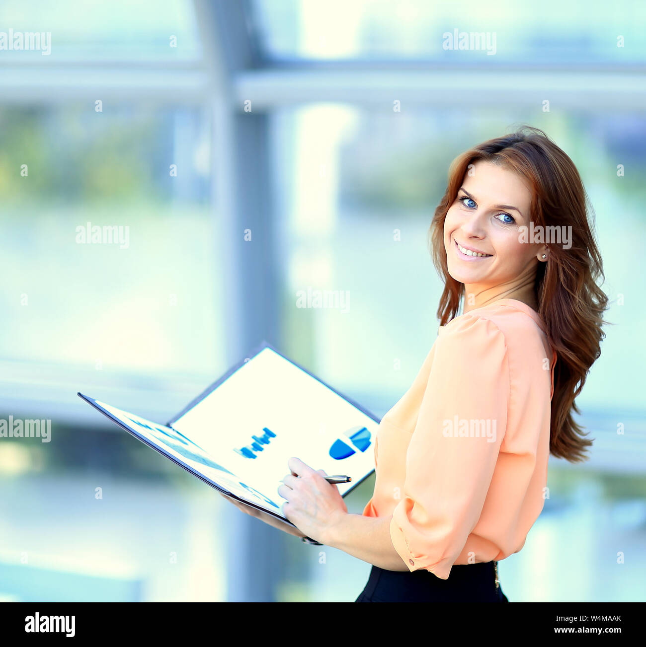 attractive modern young business woman with a folder in his hand the ...