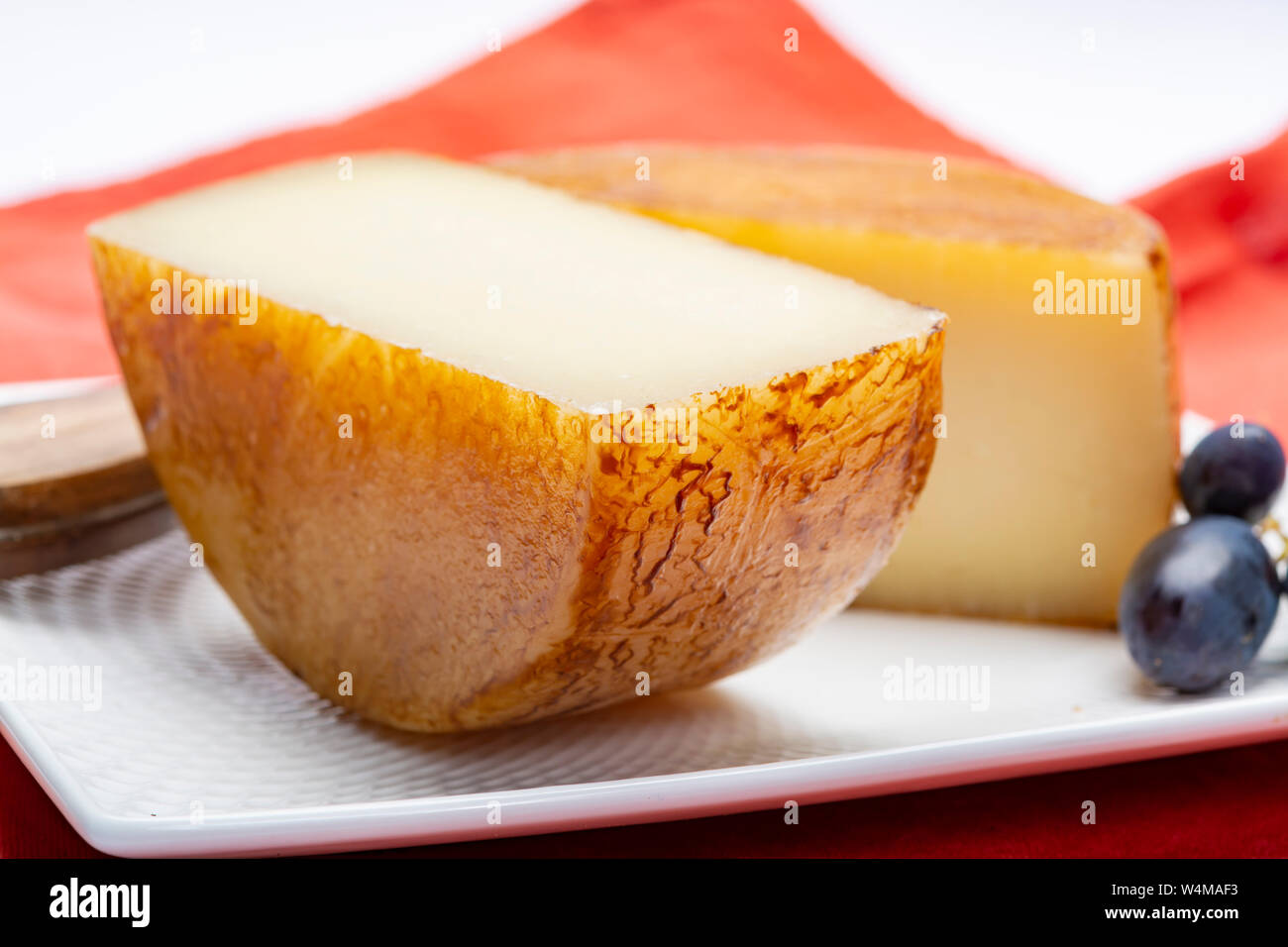 Hard Italian pecorino sheep cheese in two pieces close up isolated