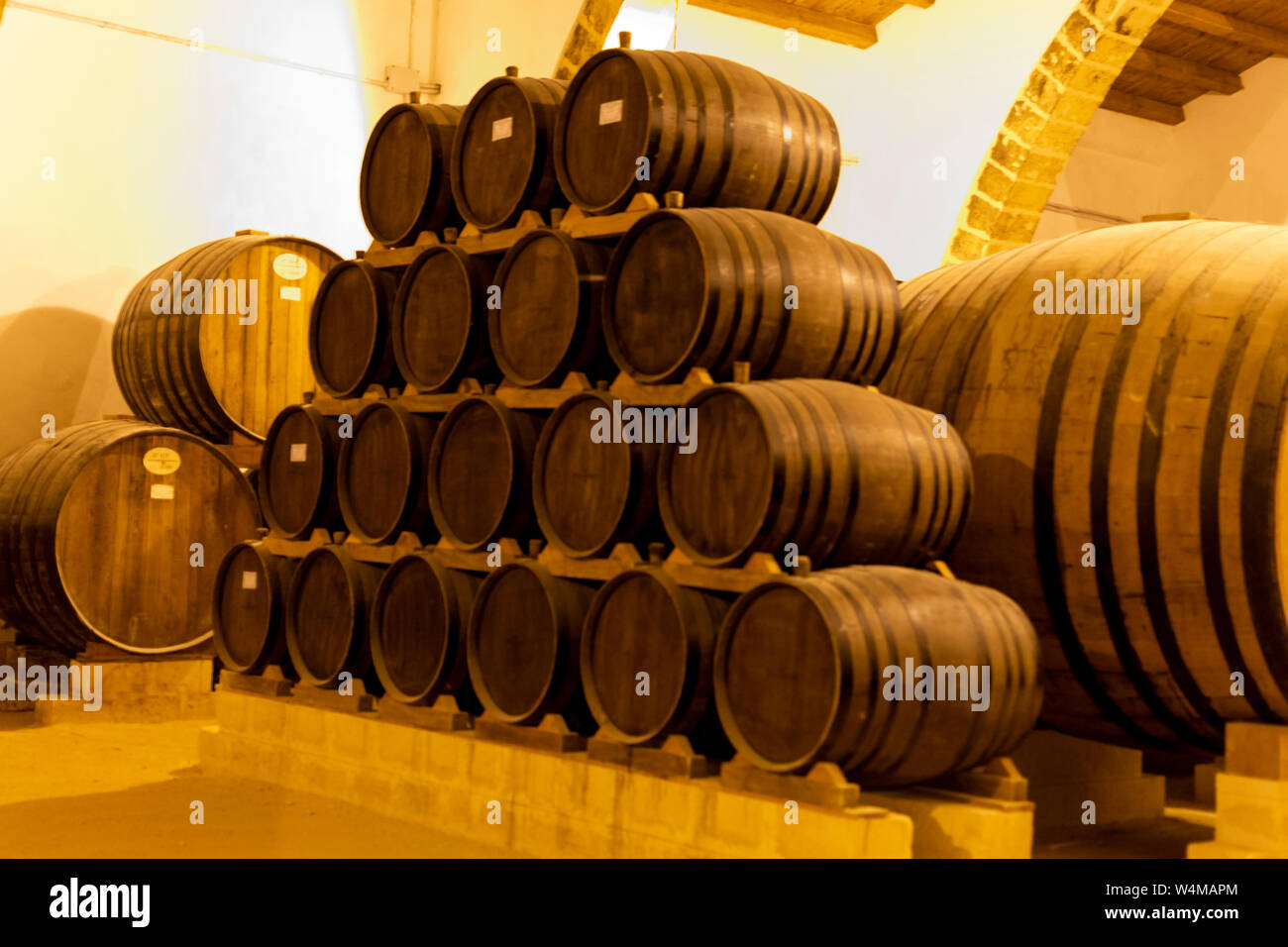 Vintage wine cellar with old oak barrels, production of fortified dry