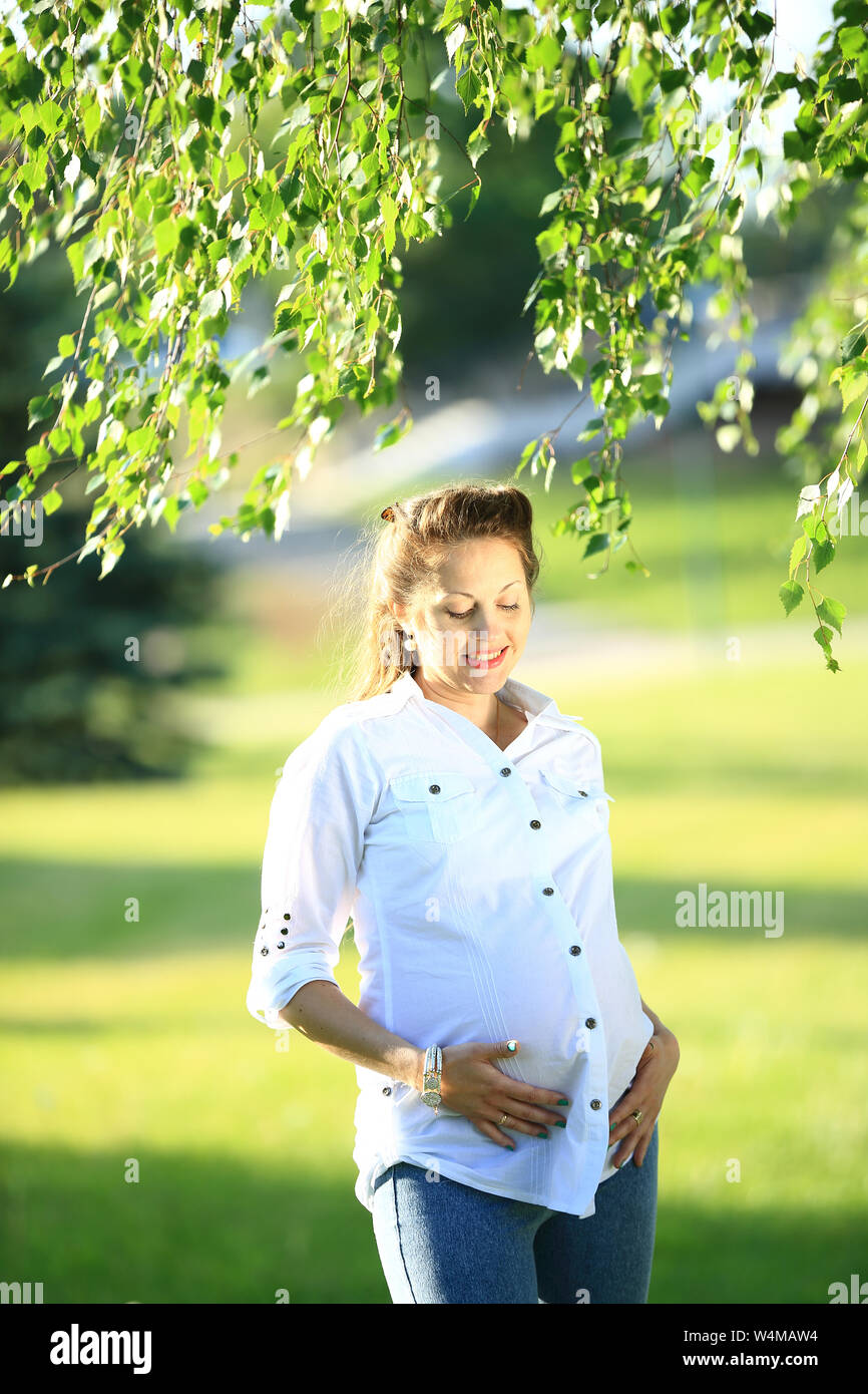 beautiful pregnant woman on a walk in the Park on a summer day Stock ...