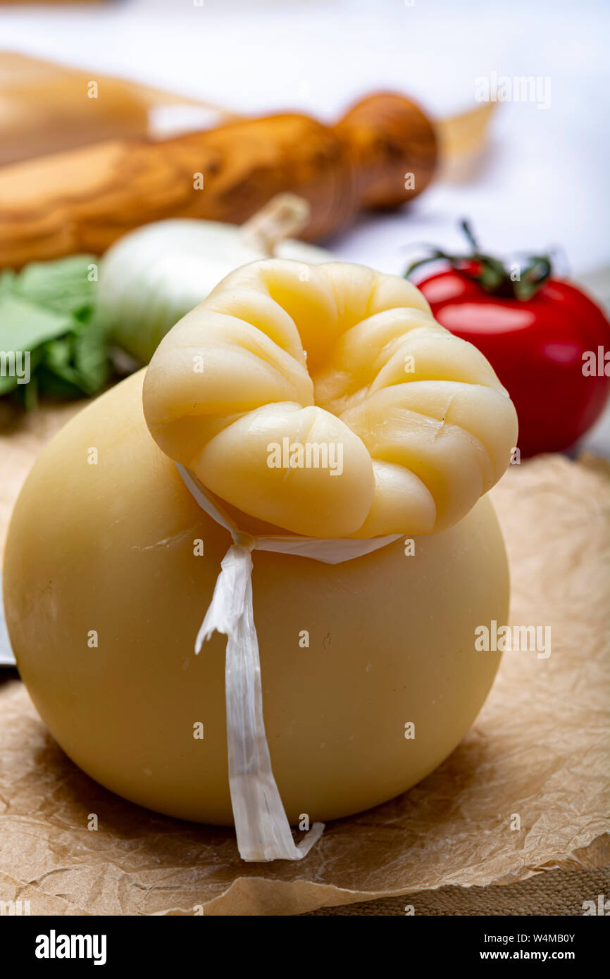 Cheese collection, Italian provolone or provola caciocavallo hard cheese in teardrop form served on old paper close up Stock Photo