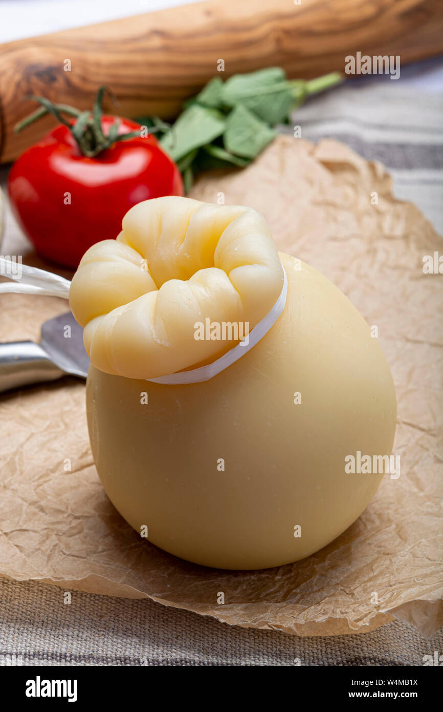 Cheese collection, Italian provolone or provola caciocavallo hard cheese in teardrop form served on old paper close up Stock Photo