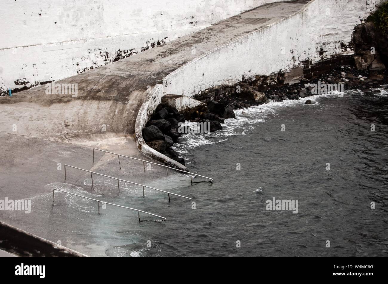 Empty dam pathway leading down to the water Stock Photo Alamy