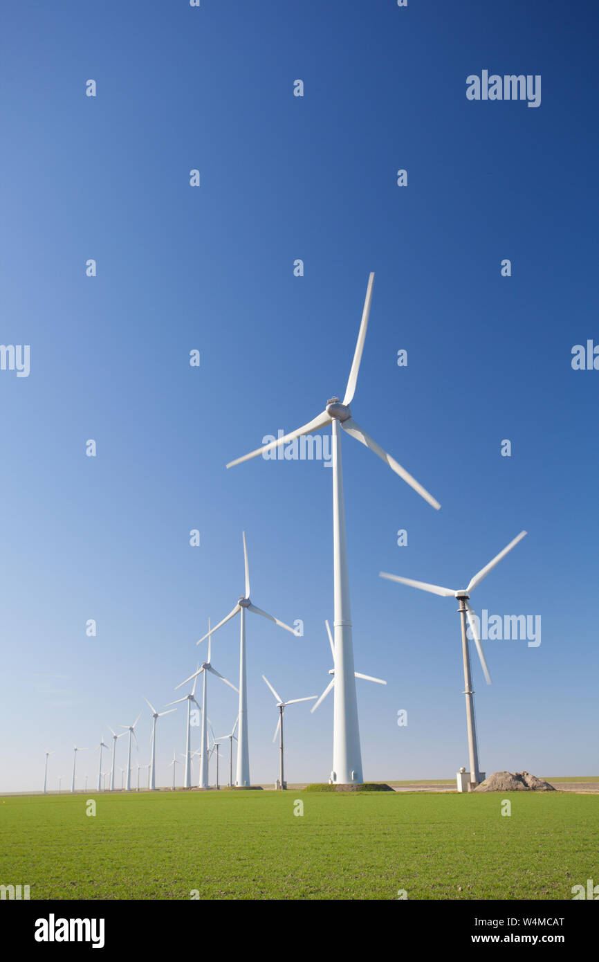 Wind turbines in Holland producing clean and sustainable energy to help against global warming Stock Photo
