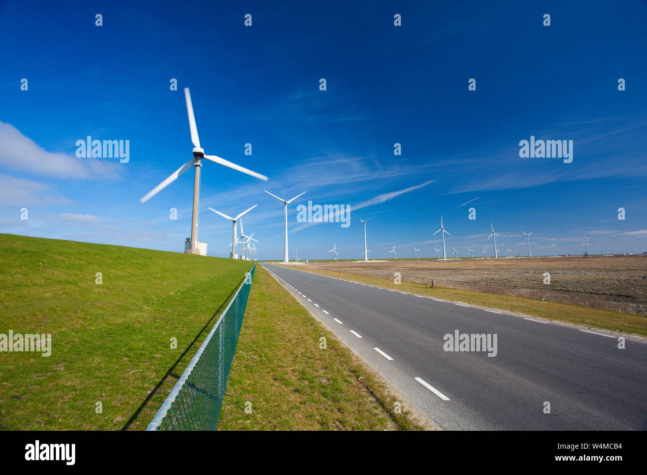 Wind turbines in the Netherlands producing green energy for a sustainable green planet Stock Photo