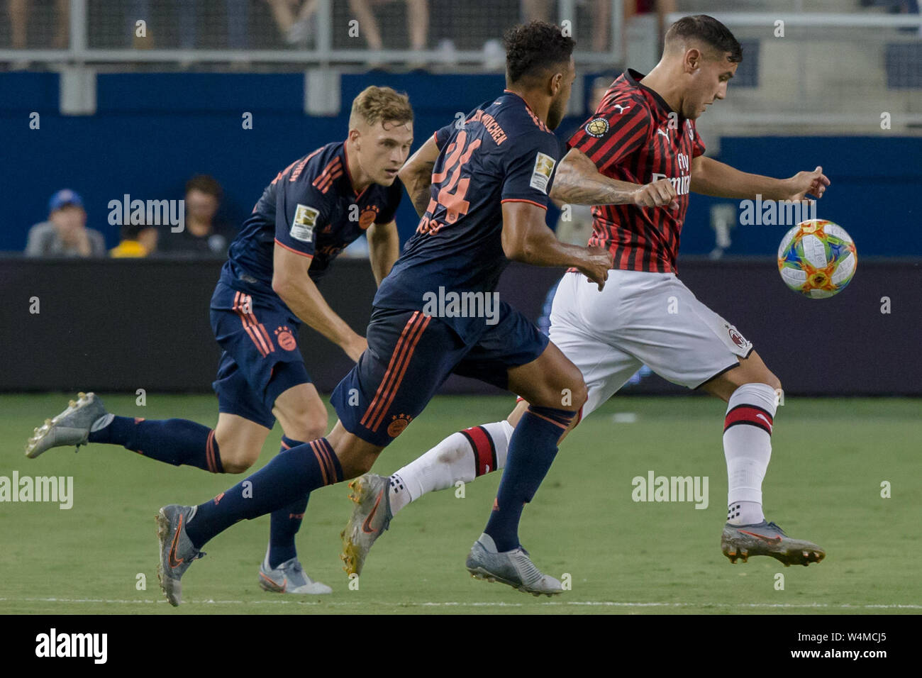 Kansas City, Kansas, USA. 23rd July, 2019. From r-l, AC Milan defender Theo Hernandez #19 takes the offense against FC Bayern Munich midfielder Corentin Tolisso #24 and FC Bayern Munich defender Joshua Kimmich #32 during the 1st half of the game. Credit: Serena S.Y. Hsu/ZUMA Wire/Alamy Live News Stock Photo