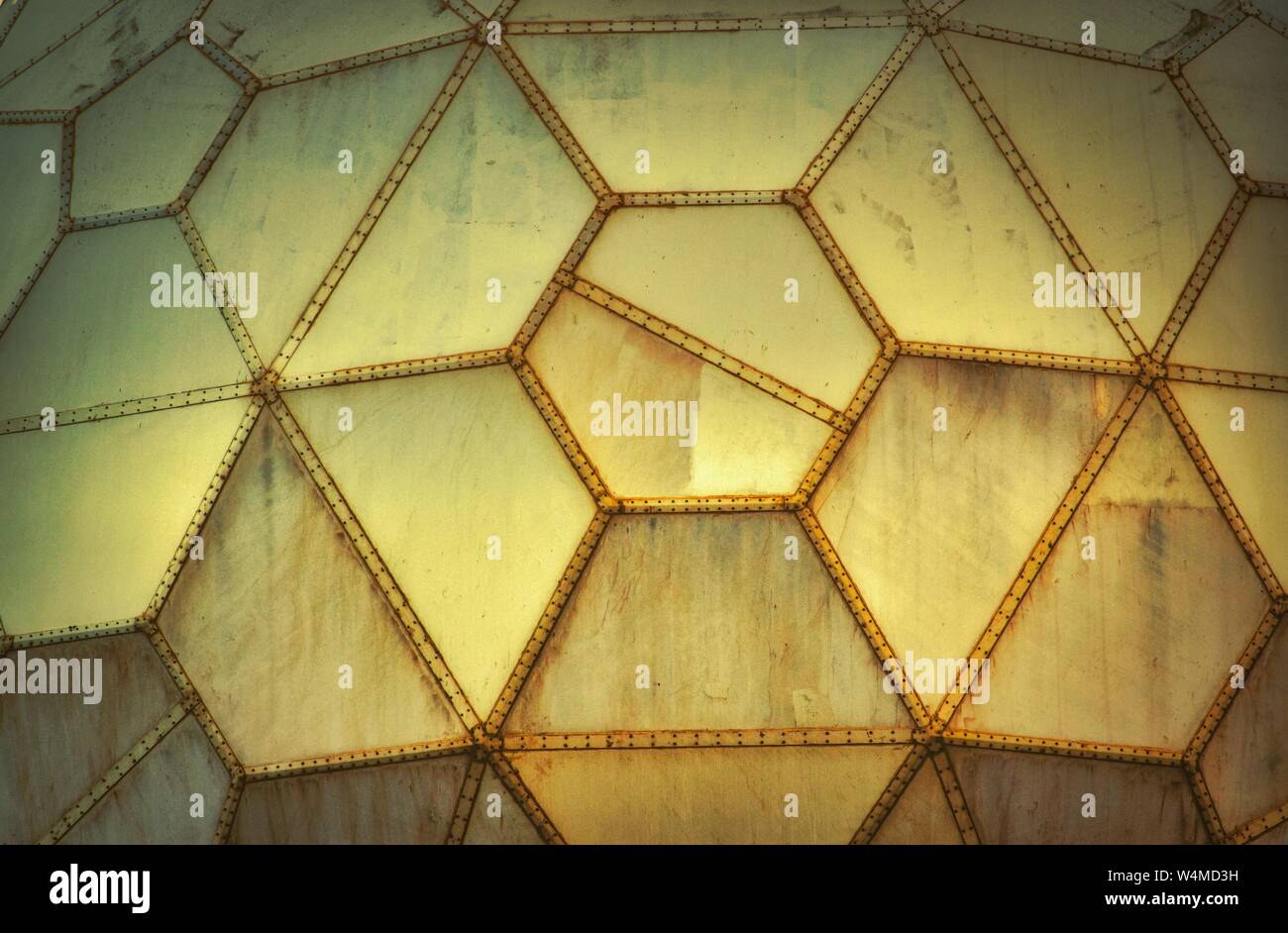 Yellow futuristic grungy wall panels made of geometric shapes Stock Photo