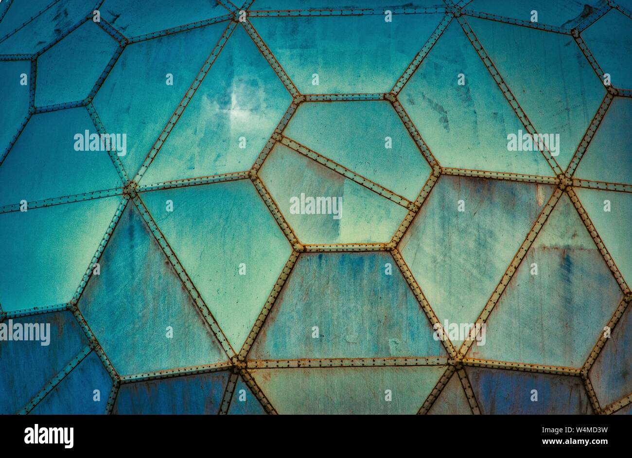 Blue futuristic grungy wall panels made of geometric shapes Stock Photo