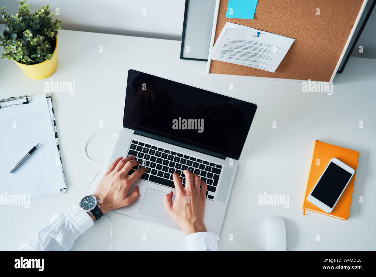 High angle view of unrecognizable man working on laptop in office Stock Photo