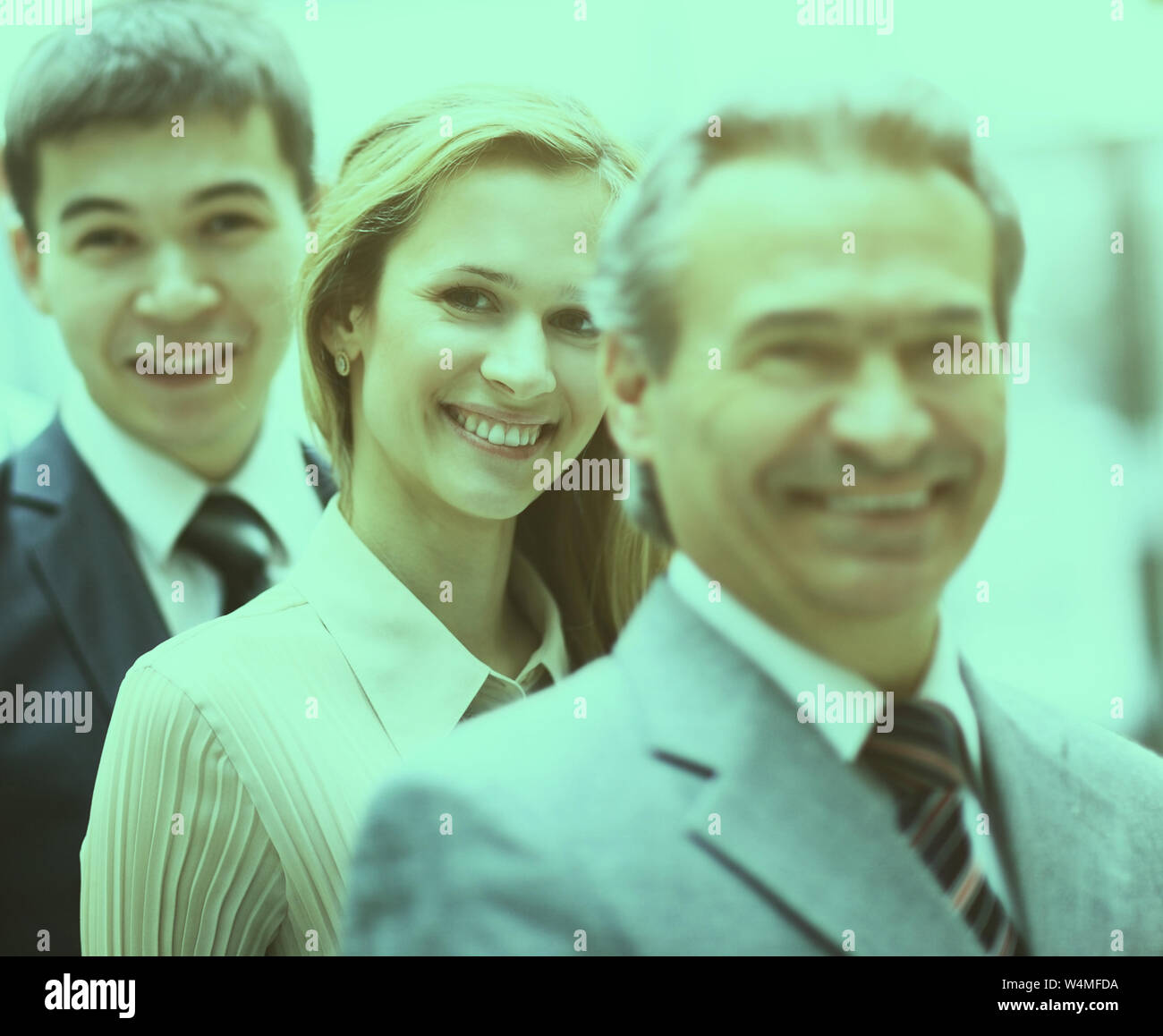 Happy smiling business team standing in a row at the office Stock Photo ...