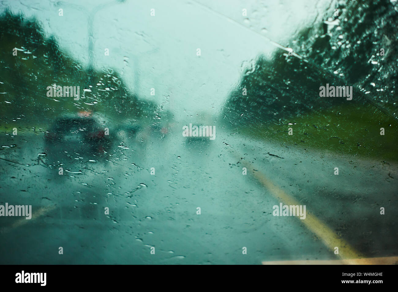 blurred view of road traffic on a rainy day through the car window ...