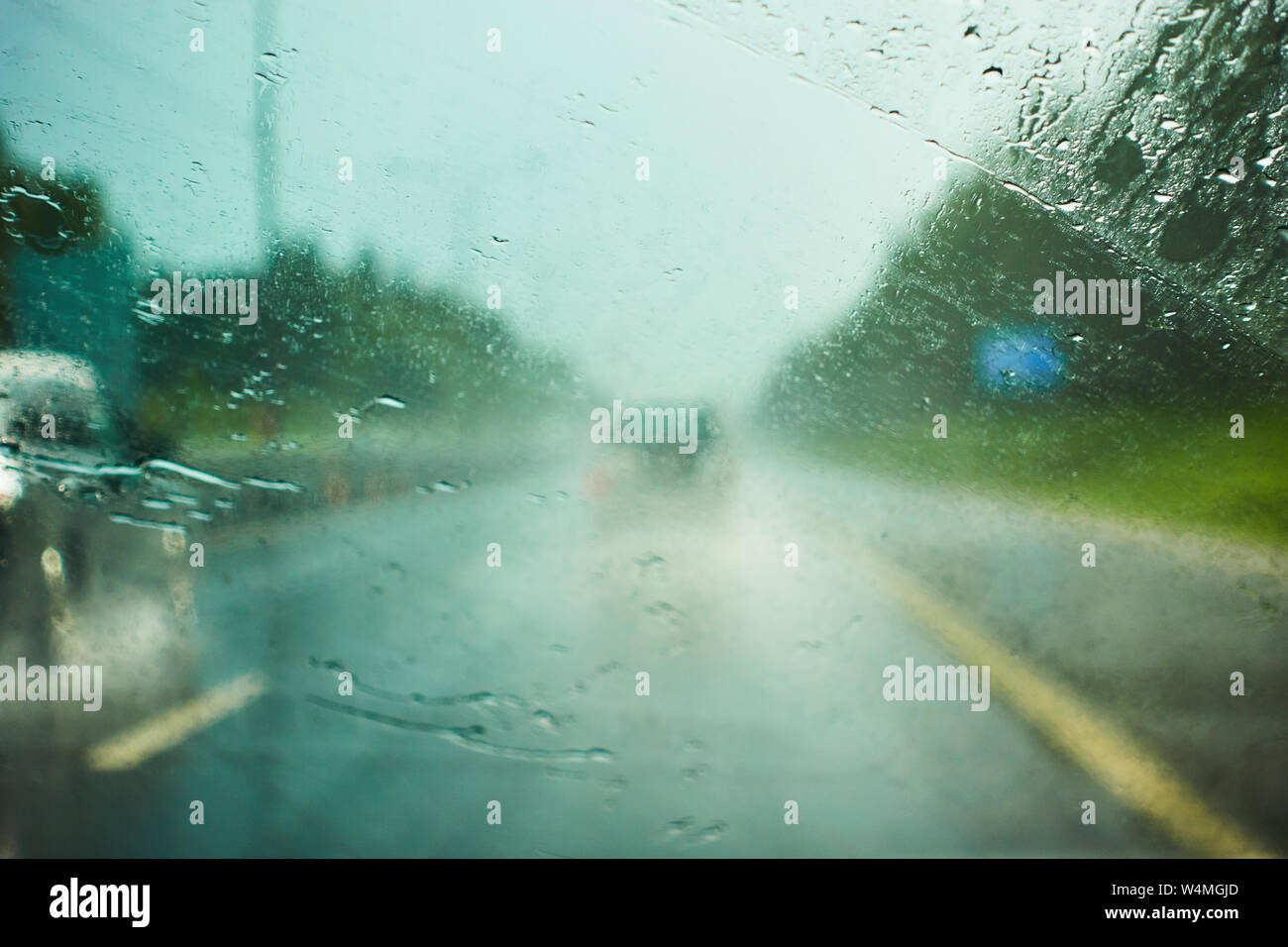 blurred view of road traffic on a rainy day through the car window ...