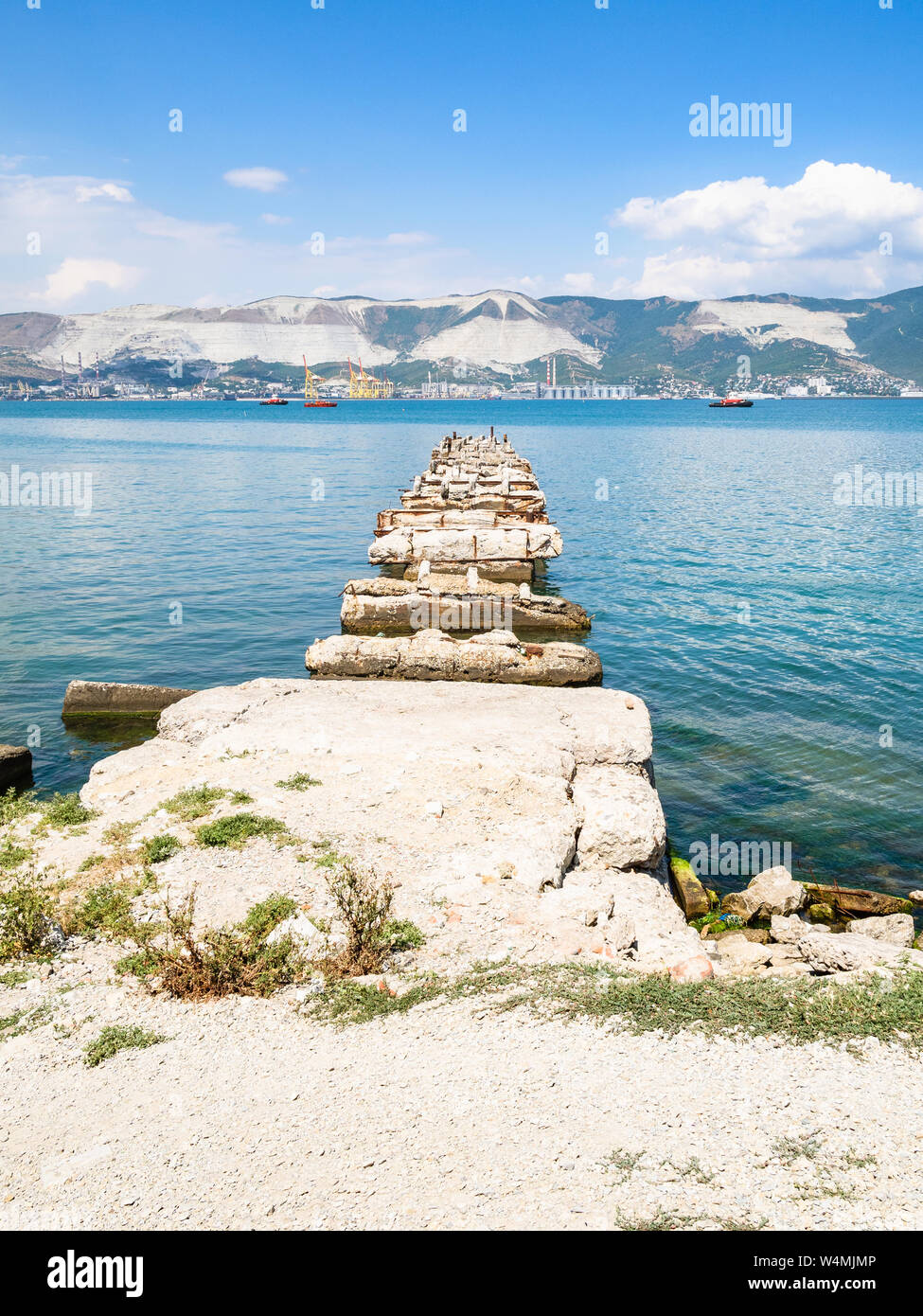 travel to Kuban region in Krasnodar Krai in Russia - old broken pier in Tsemes Bay of Black Sea in Novorossiysk city Stock Photo