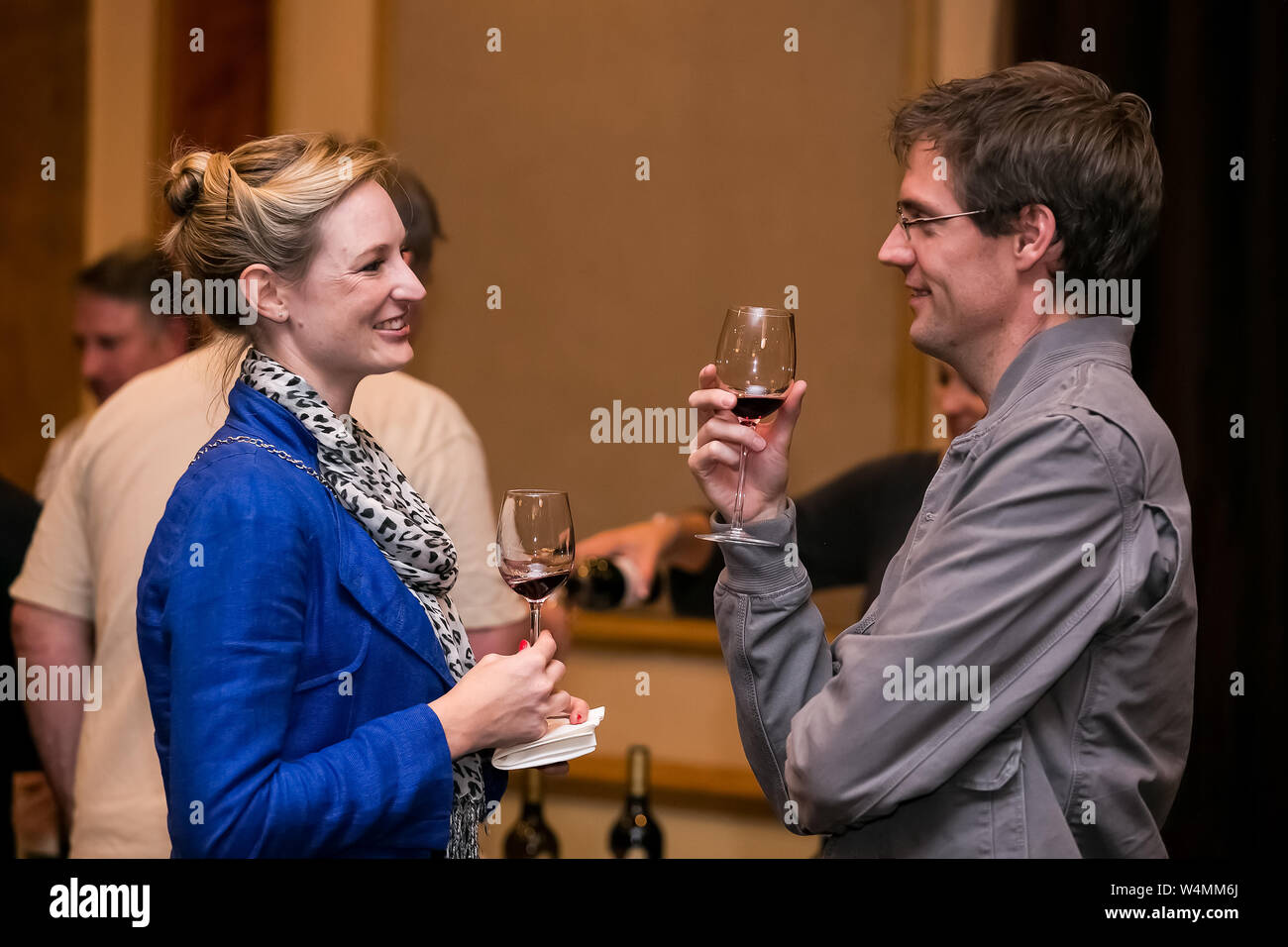 Johannesburg, South Africa - May 10 2013: Sophisticated people sampling wine at a wine tasting event Stock Photo