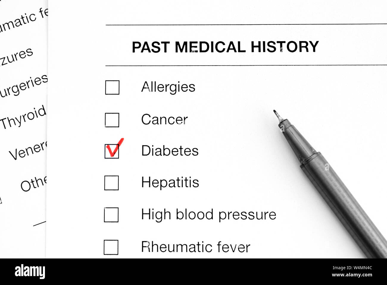 Past medical history questionary with marks on word Diabetes and pen