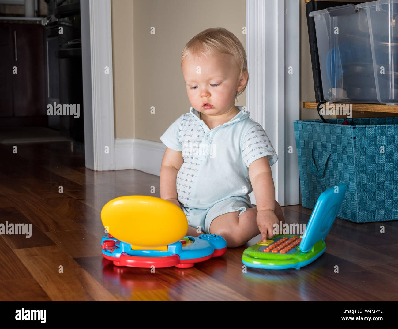 Infant caucasian boy working on two computers at the same time Stock Photo