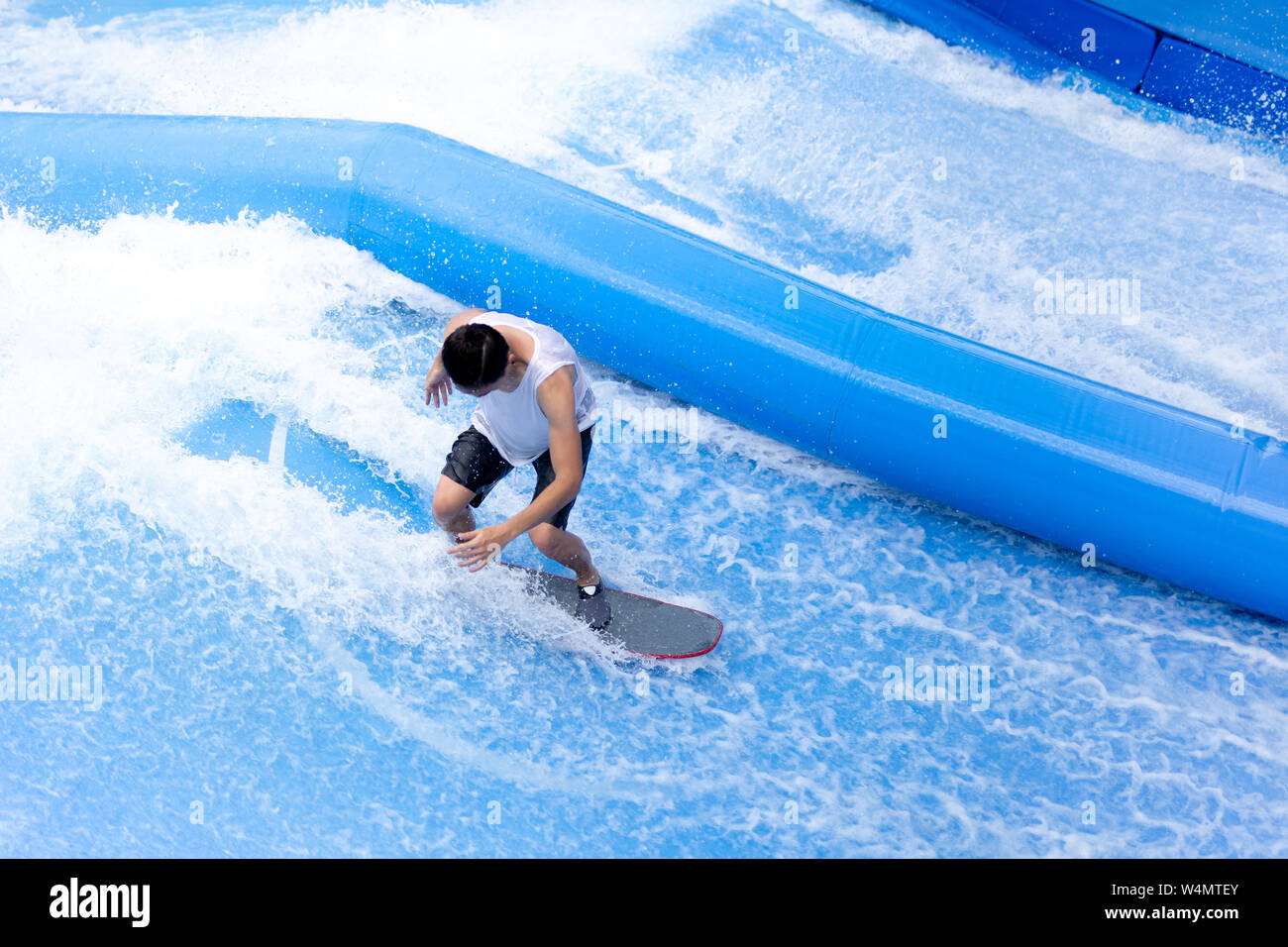 unidentified man playing surfboard indoor extreme sport Stock Photo Alamy