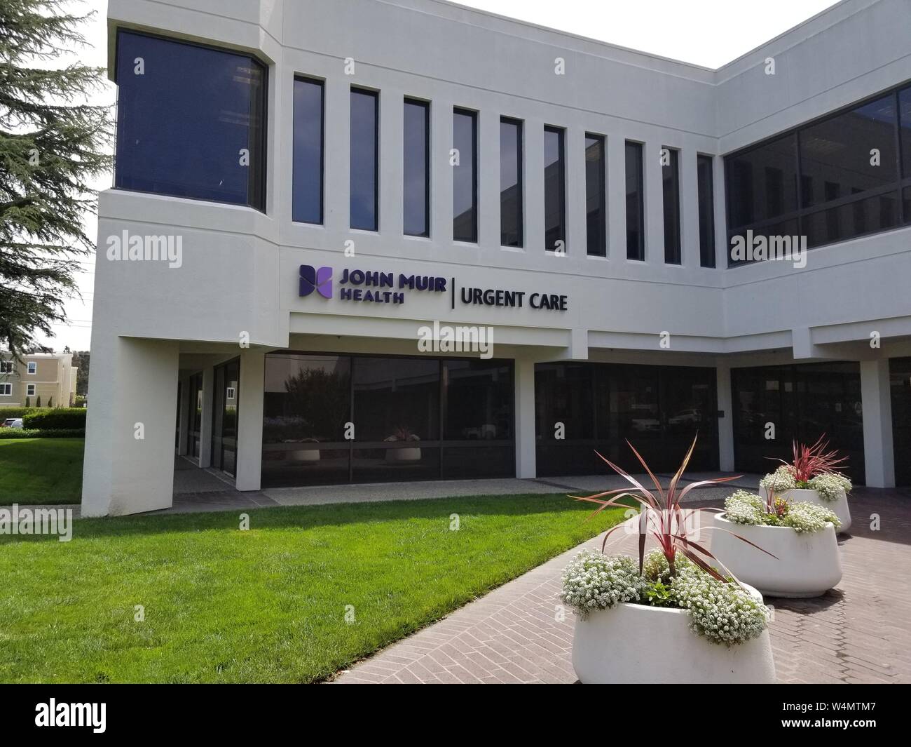 Facade with sign and logo at John Muir Health Urgent Care center in San Ramon, California, June 28, 2019. () Stock Photo