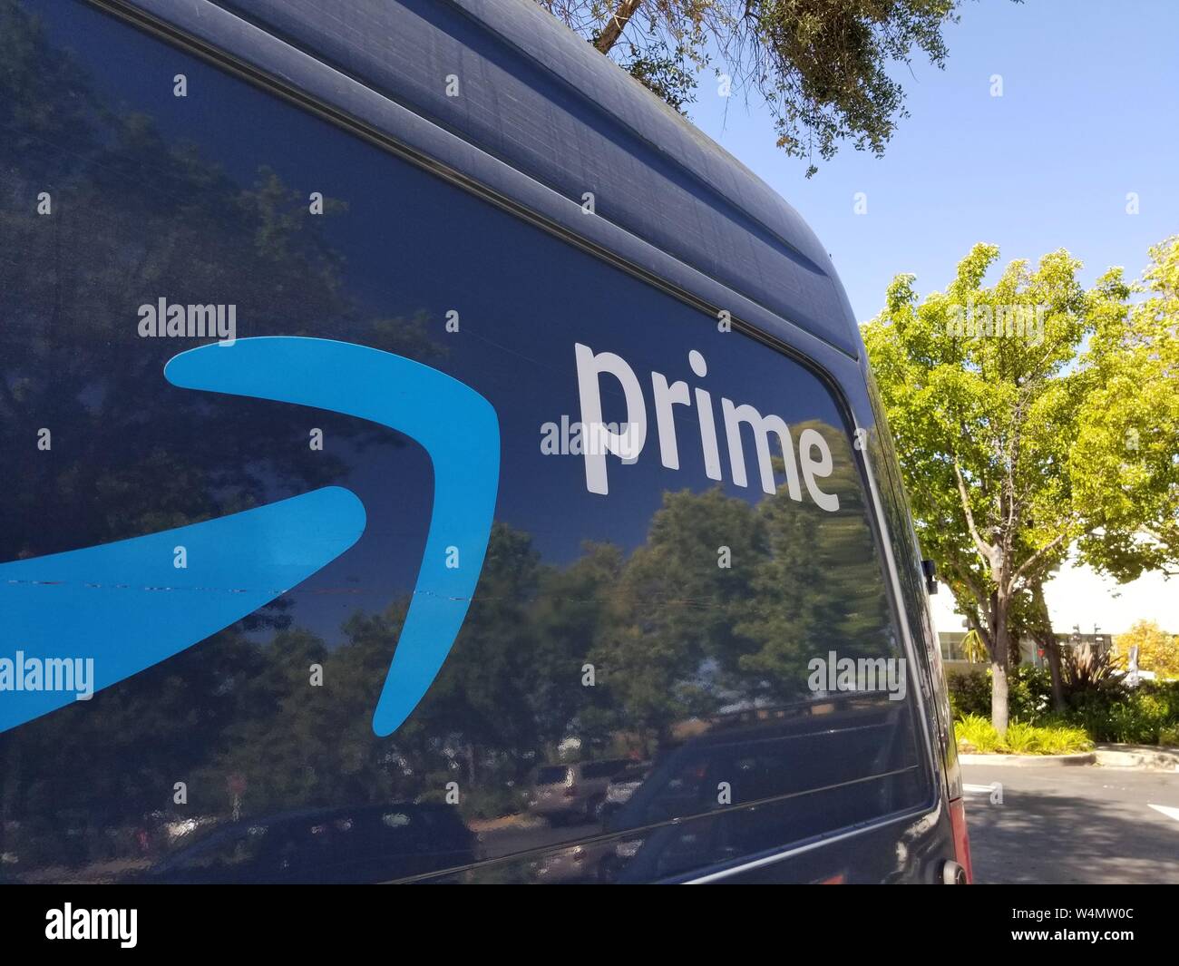Close-up of logo for Amazon Prime service on the side of a branded delivery truck in San Ramon, California; Amazon announced that it would hire thousands more delivery drivers to increase 1 day shipping options beginning in 2019, July 12, 2019. () Stock Photo