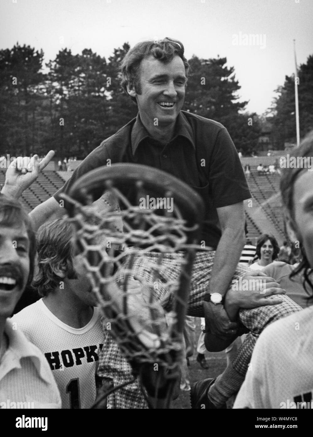 Johns Hopkins University Hall of Fame lacrosse coach Bob Scott smiles as he rests on the shoulders of players on his lacrosse team in celebration at Johns Hopkins University, Baltimore, Maryland, 1976. From the Historical Photographs Collection. () Stock Photo