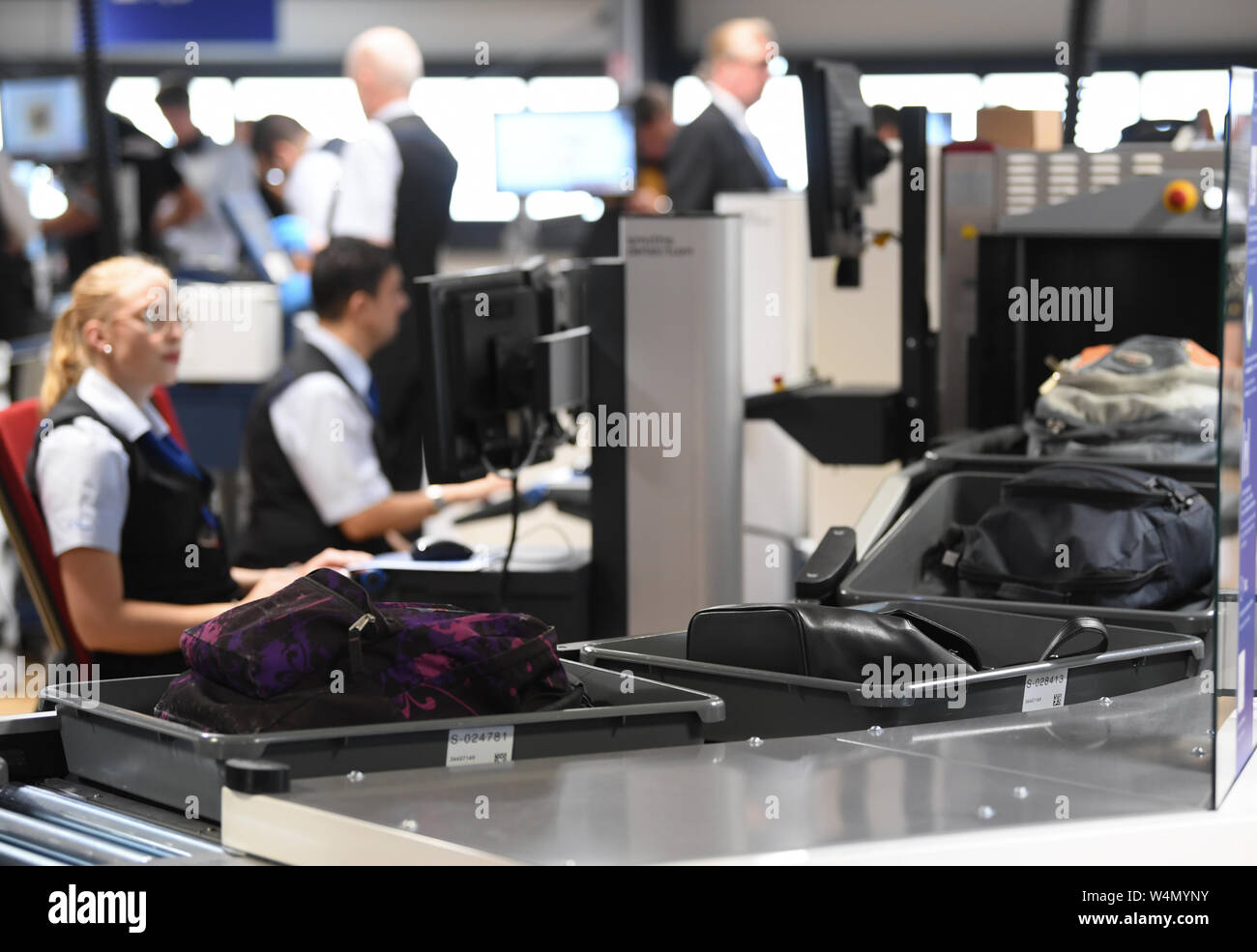 24 July 2019, Hessen, Frankfurt/Main: The hand luggage of passengers travelling by air is transported to a baggage scanner in a newly constructed hall in Terminal 1 of Frankfurt Airport at passenger screening. The seven new control lanes are intended to ensure smoother operation. Thanks to a new configuration, more passengers per hour can be guided through than with the technology previously used. Photo: Arne Dedert/dpa Stock Photo